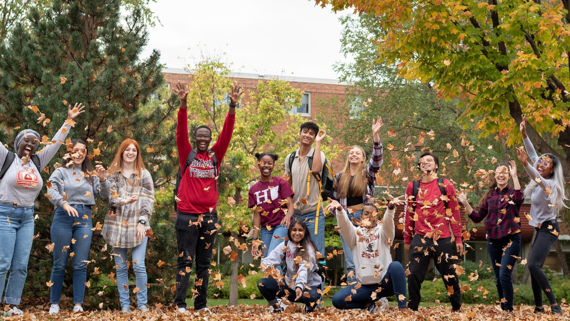  Hamline happy students at Hamline during the fall blowing the leafs
